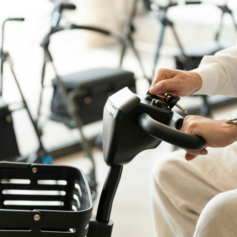 Older man in an orthopedic shop trying out an electric scooter